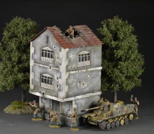 Two-story building with bullet holes and bombed roof